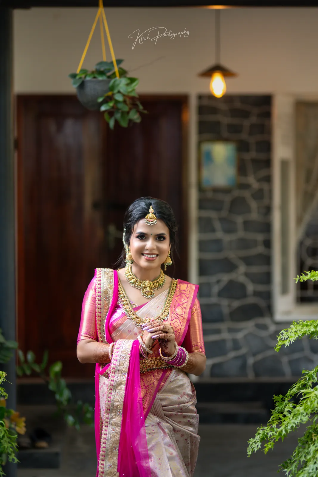 Bride in a pink saree photographed in warm evening light