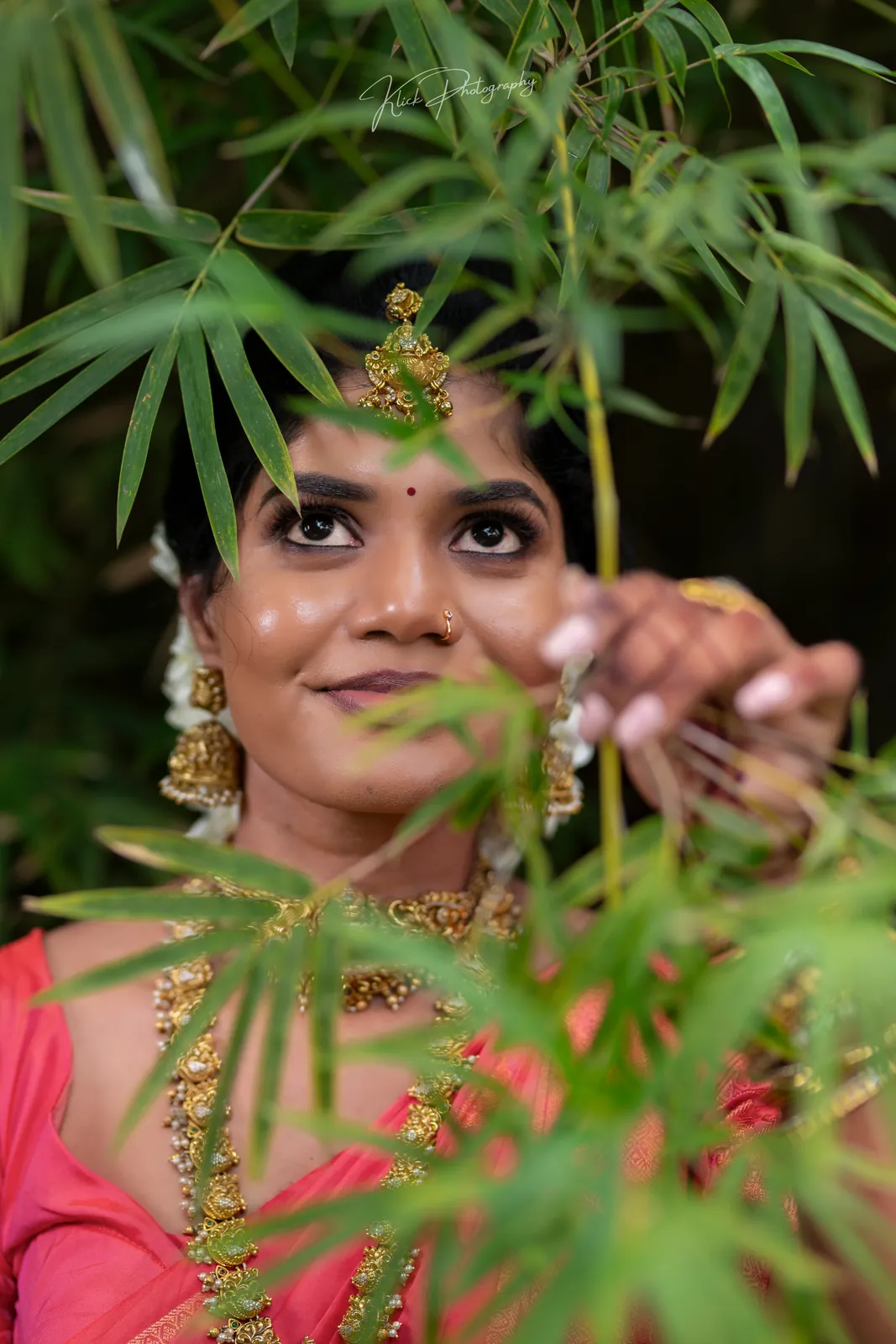 Candid bridal close-up through green leaves