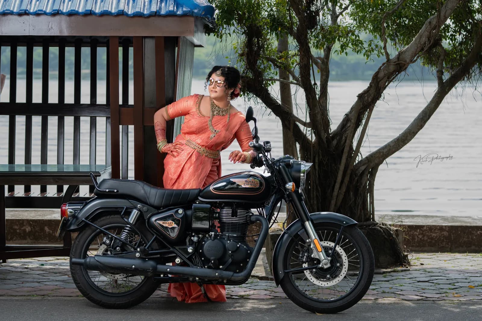 Fashion portrait with a classic motorbike by the lagoon