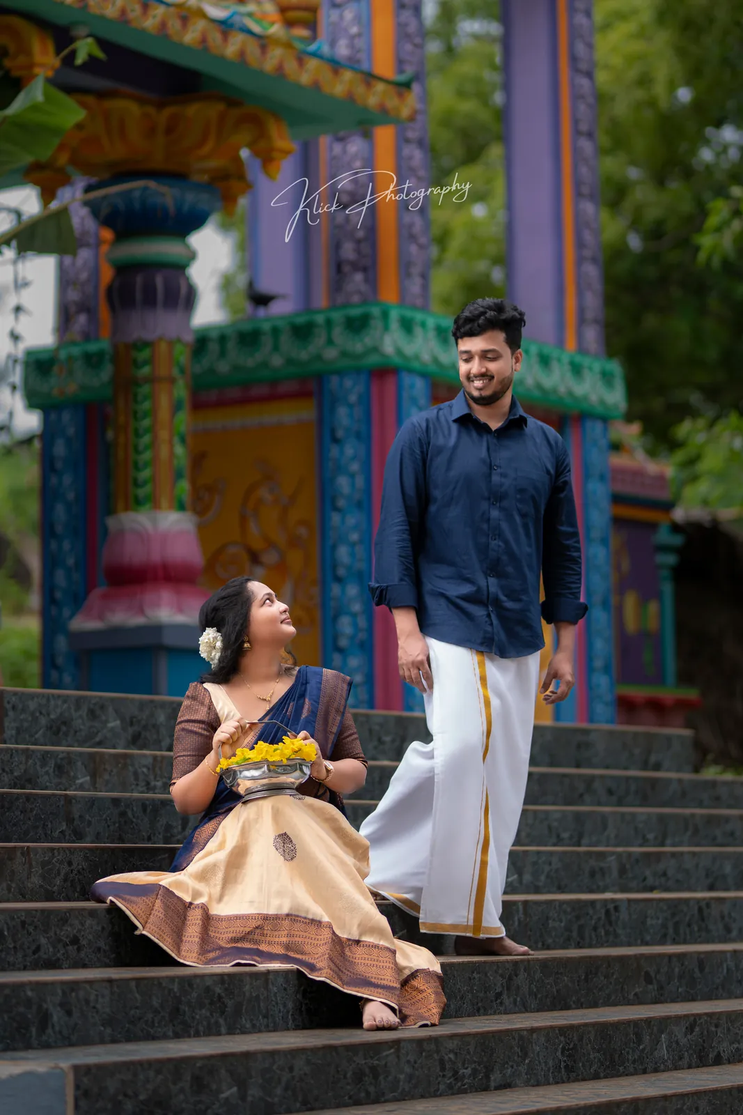 Couple in traditional dress seated on temple steps