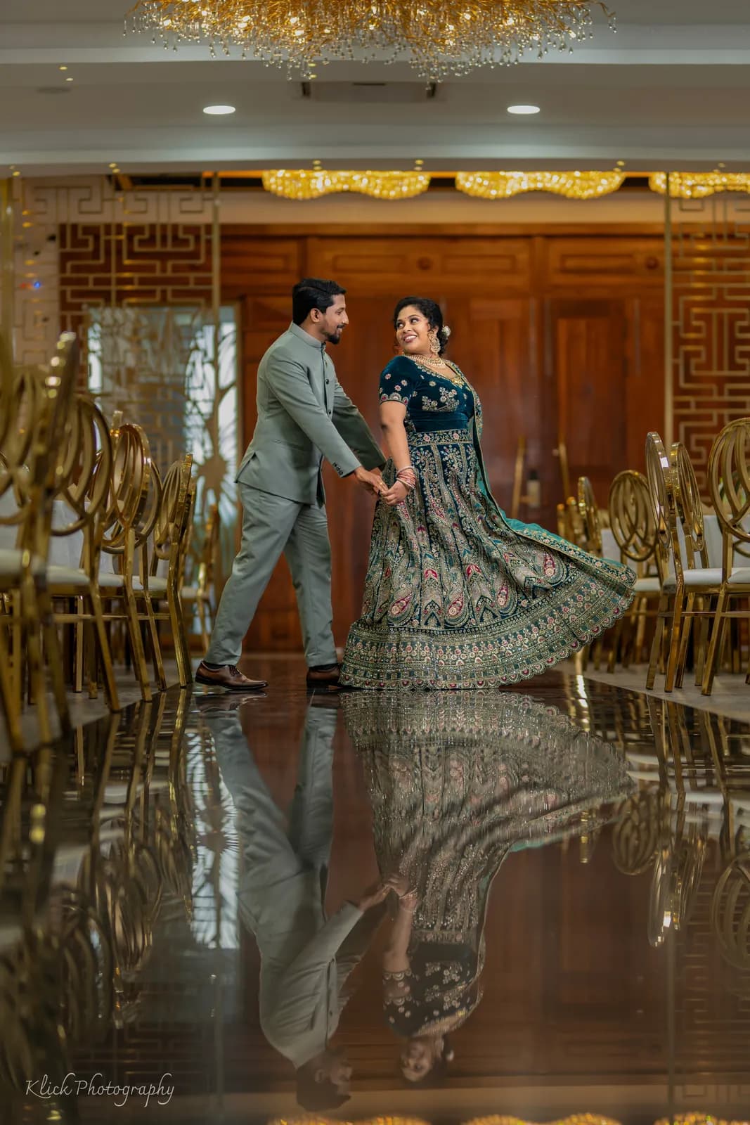 Newlyweds dancing in a reception hall with mirrored floor