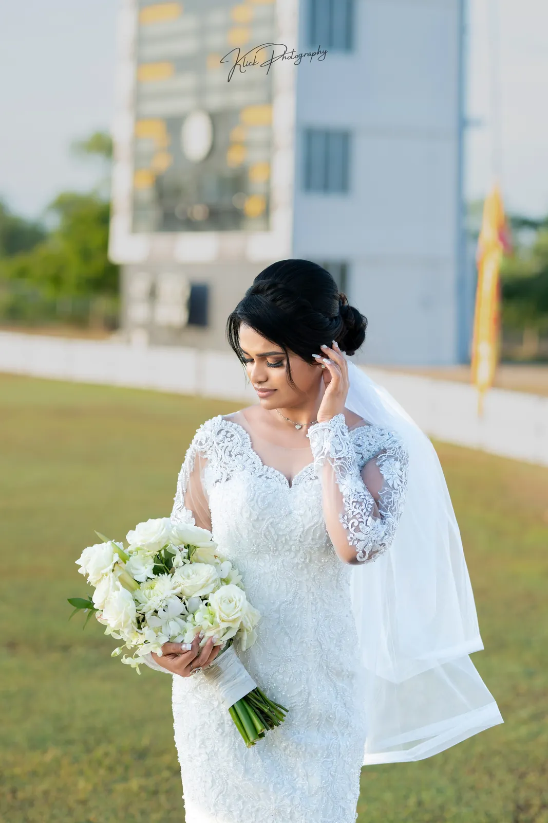 Bride holding a white bouquet in soft daylight