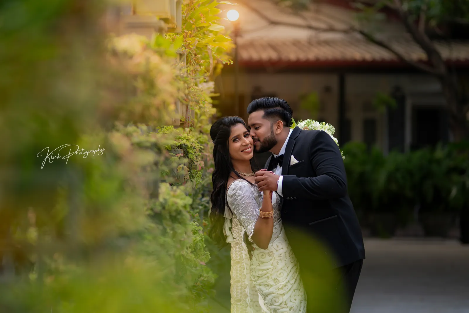 Couple embracing in a garden at golden hour