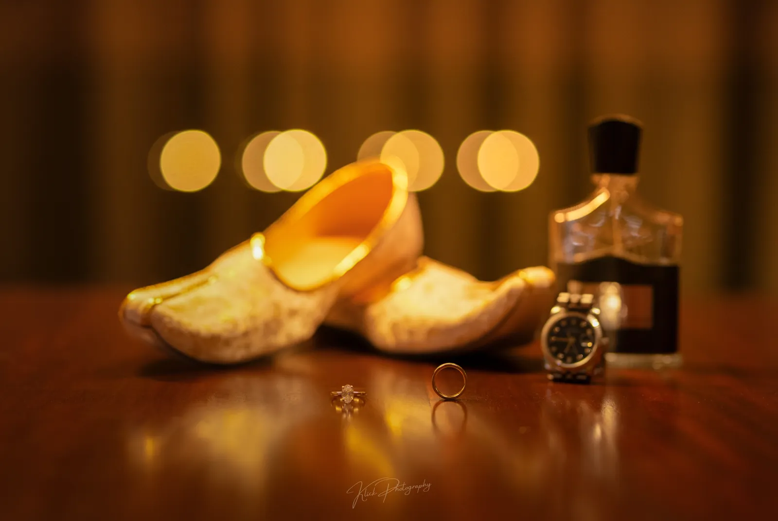 Bridal shoes, perfume and watch arranged as a detail still life